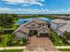 Luxury home with lake view, paver driveway, and basketball court at 6358 Rivo Lakes Blvd, Sarasota, FL 34241
