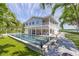 Expansive pool and patio area, showcasing a perfect space for outdoor entertaining by the waterfront property at 750 Penfield St, Longboat Key, FL 34228