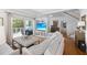 Living room with hardwood floors, access to deck, and stairs at 750 Penfield St, Longboat Key, FL 34228