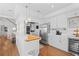 Modern kitchen with white cabinets and stainless steel appliances at 750 Penfield St, Longboat Key, FL 34228