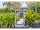 Welcoming walkway to the home with lush landscaping and a mailbox at 750 Penfield St, Longboat Key, FL 34228