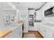 Modern kitchen with white cabinets and a farmhouse sink at 750 Penfield St, Longboat Key, FL 34228