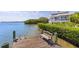 Private wooden dock with bench overlooking the water at 750 Penfield St, Longboat Key, FL 34228