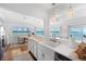 Open concept kitchen with white cabinets and a butcher block island at 750 Penfield St, Longboat Key, FL 34228