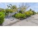 Attractive front yard with lush landscaping and a paved driveway at 750 Penfield St, Longboat Key, FL 34228