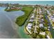 Aerial view of waterfront home community with lush landscaping and canals at 750 Penfield St, Longboat Key, FL 34228
