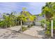 Elegant home with a spacious paved driveway and lush landscaping at 750 Penfield St, Longboat Key, FL 34228