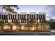 Modern townhouses with commercial spaces on the ground floor, illuminated at dusk at 1611 4Th St # B6, Sarasota, FL 34236