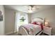 Bright bedroom with a white bed frame and floral bedding at 2017 Lovoy Ct, North Port, FL 34288