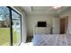Main bedroom with plush bed, dresser, and backyard access at 2017 Lovoy Ct, North Port, FL 34288