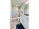 Modern bathroom with a walk-in shower and white cabinets at 2017 Lovoy Ct, North Port, FL 34288