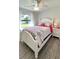 Bright bedroom with a white bed frame and floral bedding at 2017 Lovoy Ct, North Port, FL 34288