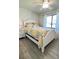 Charming bedroom with white bed frame and yellow bedding at 2017 Lovoy Ct, North Port, FL 34288