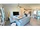Bright living room with light grey sofa and view into kitchen and dining area at 2017 Lovoy Ct, North Port, FL 34288