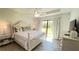 Spacious primary bedroom with plush bedding and backyard access at 2017 Lovoy Ct, North Port, FL 34288
