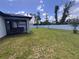 Spacious backyard with grassy area and screened porch at 2017 Lovoy Ct, North Port, FL 34288