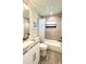 Bathroom with granite countertop vanity, shower/tub combo, and wood-look flooring at 2017 Lovoy Ct, North Port, FL 34288