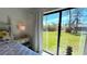 Bedroom with sliding glass doors opening to backyard view at 2017 Lovoy Ct, North Port, FL 34288
