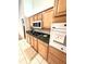 Kitchen with light wood cabinets, dark countertops, and appliances at 623 147Th E St, Bradenton, FL 34212