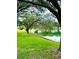 Serene lakefront property with lush landscaping and mature trees at 623 147Th E St, Bradenton, FL 34212