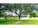 Peaceful lakefront view with lush greenery and mature trees at 623 147Th E St, Bradenton, FL 34212
