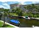Canal view with boats and lush greenery from screened balcony at 1350 N Portofino Dr # 310, Sarasota, FL 34242