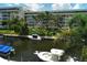 View of the canal with boats and lush greenery from screened balcony at 1350 N Portofino Dr # 310, Sarasota, FL 34242