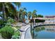 Relaxing waterfront patio area with tables, benches and umbrellas at 1350 N Portofino Dr # 310, Sarasota, FL 34242