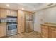 Kitchen with light wood cabinets, stainless steel appliances, and granite countertops at 1350 N Portofino Dr # 310, Sarasota, FL 34242