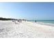 Expansive beach view with people enjoying the sand at 1350 N Portofino Dr # 310, Sarasota, FL 34242