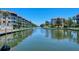 Tranquil canal view of waterfront community with boats and lush landscaping at 1350 N Portofino Dr # 310, Sarasota, FL 34242