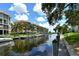 Waterfront view of Fiesta Harbor with boats and lush landscaping at 1350 N Portofino Dr # 310, Sarasota, FL 34242