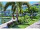 Landscaped grounds with seating area near waterway at 1350 N Portofino Dr # 310, Sarasota, FL 34242