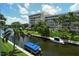 Canal view with boats and lush greenery from screened balcony at 1350 N Portofino Dr # 310, Sarasota, FL 34242