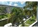 View of the canal with boats and lush greenery from screened balcony at 1350 N Portofino Dr # 310, Sarasota, FL 34242