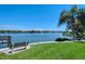 Scenic view of the water with a bench and palm trees at 1350 N Portofino Dr # 310, Sarasota, FL 34242