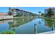 Stunning reflection of waterfront buildings in the calm canal water at 1350 N Portofino Dr # 310, Sarasota, FL 34242