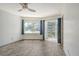 Bright bedroom with tile flooring, large window, and access to a balcony at 1350 N Portofino Dr # 310, Sarasota, FL 34242
