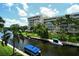 Canal view with boats and lush greenery from screened balcony at 1350 N Portofino Dr # 310, Sarasota, FL 34242