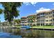 Waterfront view of Fiesta Harbor with boats and lush landscaping at 1350 N Portofino Dr # 310, Sarasota, FL 34242