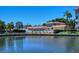 Community pool area with adjacent building and canal views at 1350 N Portofino Dr # 310, Sarasota, FL 34242