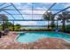 Relaxing pool and spa with a screened enclosure and lake view at 6358 Rivo Lakes Blvd, Sarasota, FL 34241