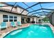 Resort-style pool and spa with covered patio and lounge chairs at 6358 Rivo Lakes Blvd, Sarasota, FL 34241