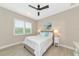 Bright bedroom with a queen bed, nightstands, and window shutters at 6358 Rivo Lakes Blvd, Sarasota, FL 34241
