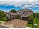 Two-story home with tile roof, two-car garage, and a basketball hoop at 6358 Rivo Lakes Blvd, Sarasota, FL 34241