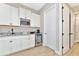 Convenient wet bar with microwave, wine cooler, and granite countertop at 6358 Rivo Lakes Blvd, Sarasota, FL 34241
