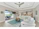 Living room boasts a white sectional sofa, pool access, and an open floor plan at 6358 Rivo Lakes Blvd, Sarasota, FL 34241