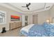 Bright bedroom featuring a king bed, dresser, and large TV at 6358 Rivo Lakes Blvd, Sarasota, FL 34241
