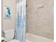 Clean bathroom with a shower/tub combo and tile surround at 6358 Rivo Lakes Blvd, Sarasota, FL 34241