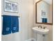 Elegant powder room with pedestal sink and mirror at 6358 Rivo Lakes Blvd, Sarasota, FL 34241